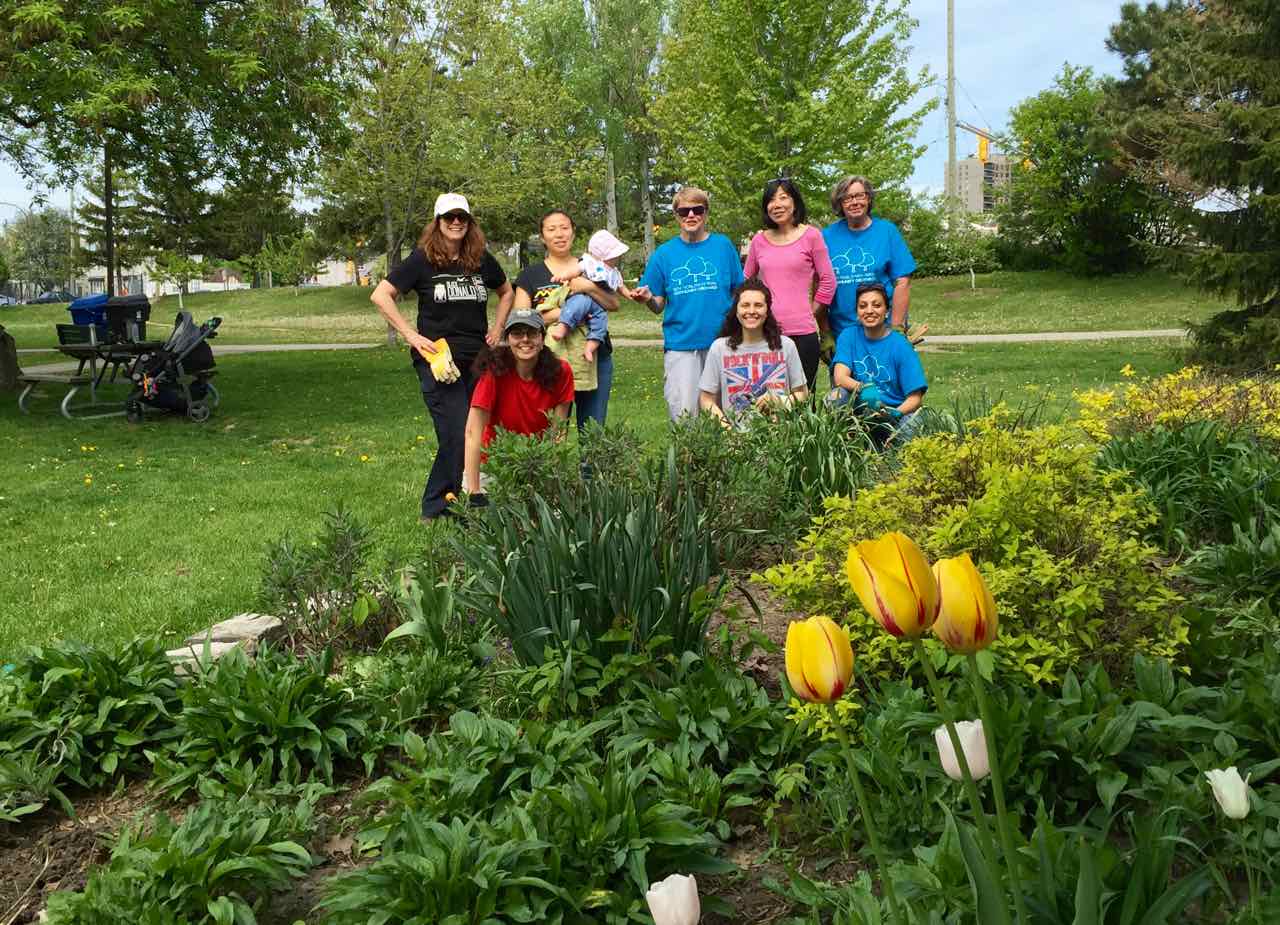 The Volunteers of the Ben Nobleman Park Community Orchard posing in front of their pollinator garden.