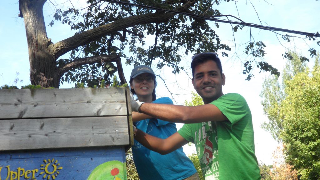 Susan and Pawaan weeding the green roof in the Ben Nobleman Park Community Orchard