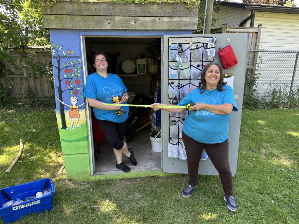 Sara and Giselle standing in front of the newly renovated orchard shed.