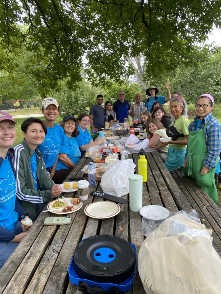 Volunteers in Ben Nobleman Park Community Orchard sitting around our harvest table. 