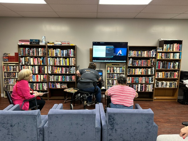 people from the retirement residence in the lounge attending a virtual apple tasting.